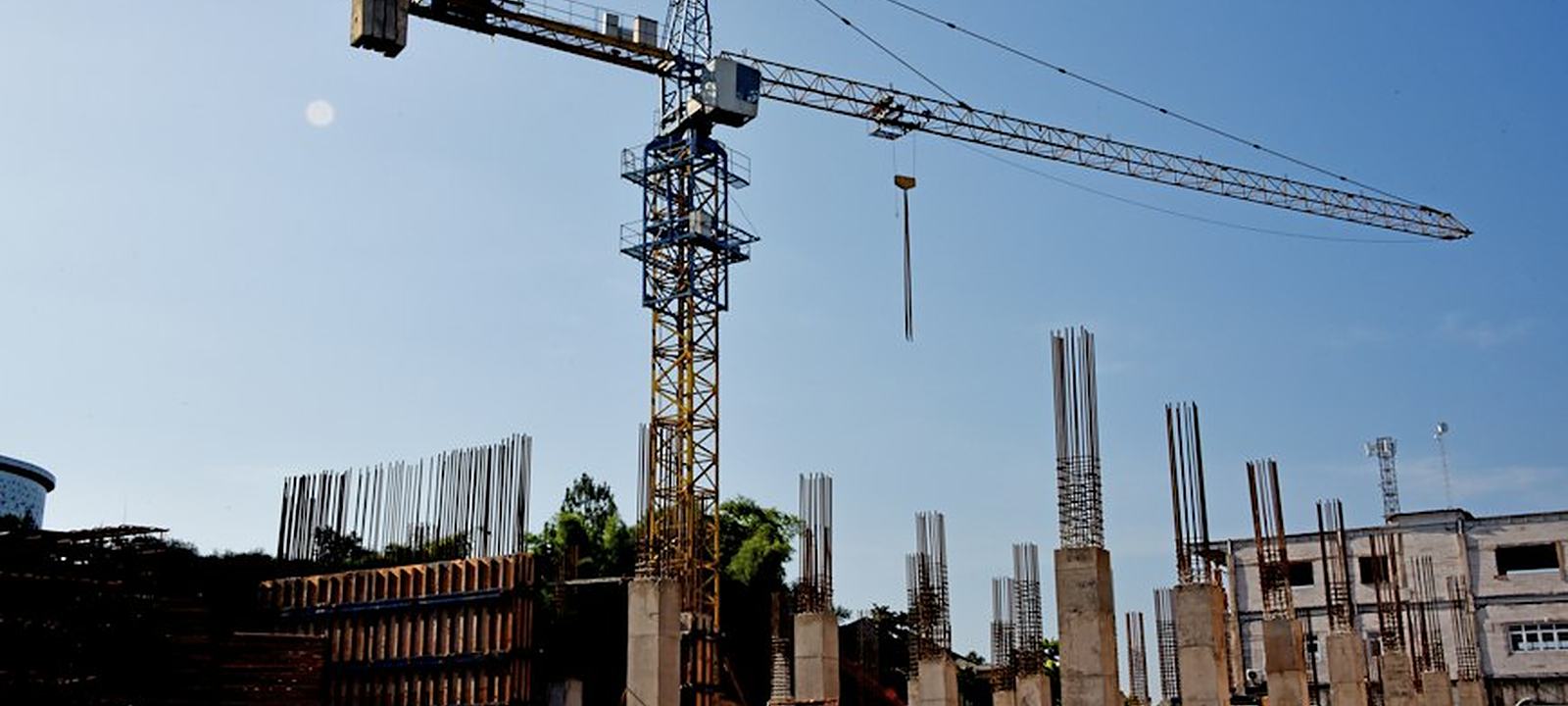 Tower crane and concrete columns on a building construction site