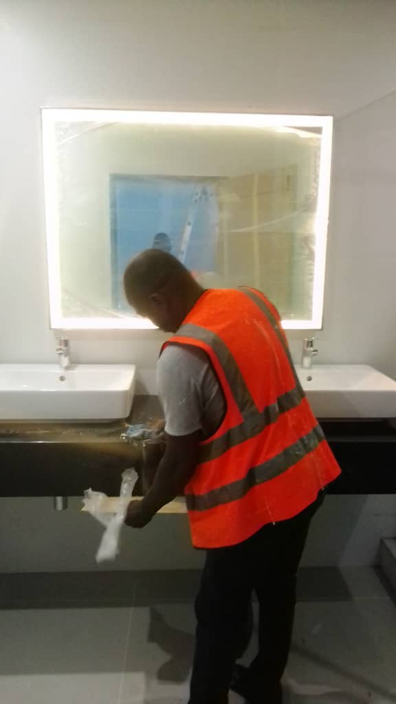 Maydok technician finishing the washroom basins and illuminated mirror at Four Points by Sheraton, Lagos
