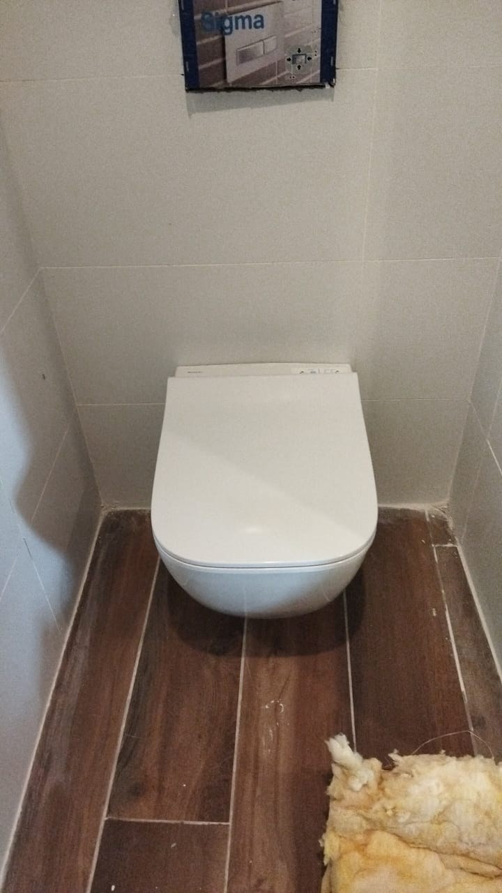 Wall-hung toilet in a tiled washroom at Four Points by Sheraton, Lagos