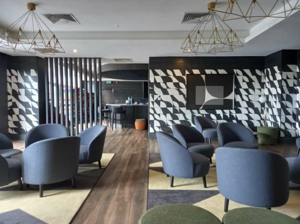 Terrace Bar lounge with patterned tile walls and blue armchairs at Four Points by Sheraton, Lagos