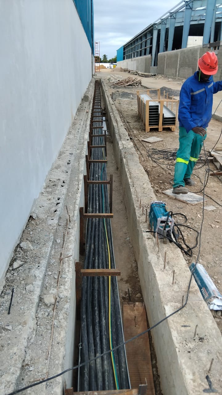 Cable trench with HV cables laid on supports beside a new building, Beira, Mozambique