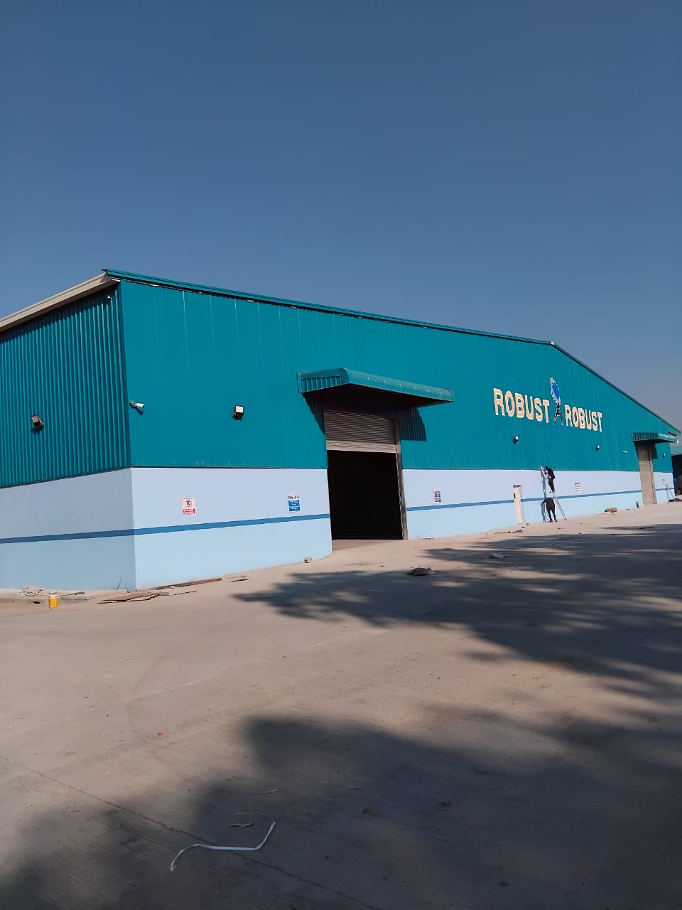 Teal Robust International warehouse building with roller shutter doors, Mozambique
