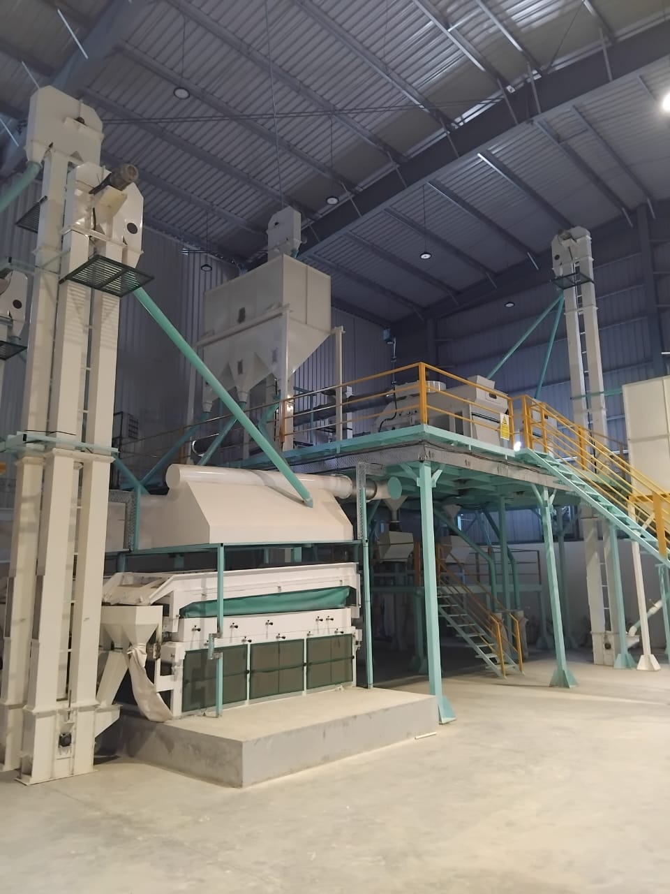 Sortex machine installation with bucket elevators and steel platform inside the plant, Mozambique