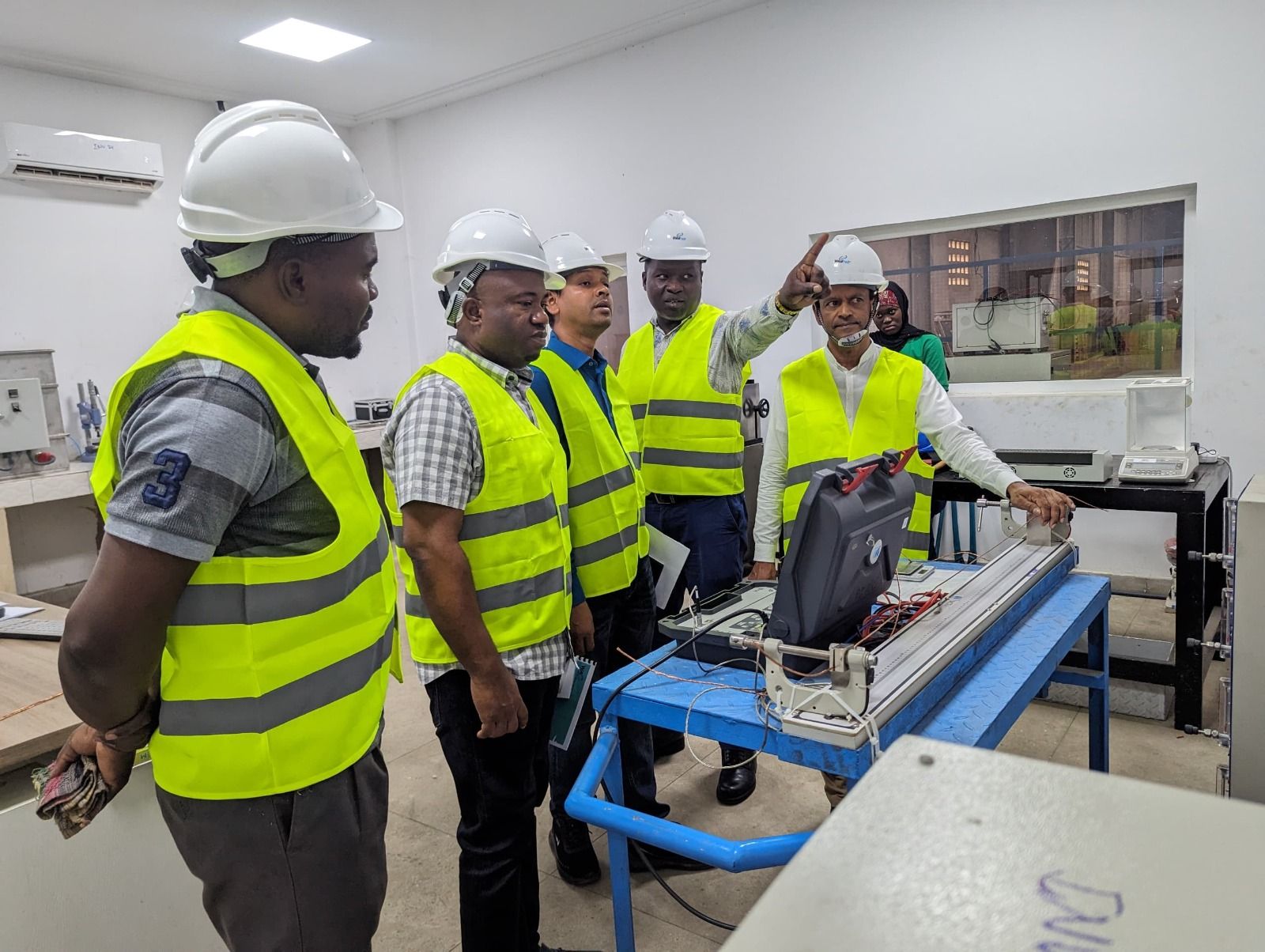 Maydok Ventures engineers in hard hats and safety vests reviewing equipment on site